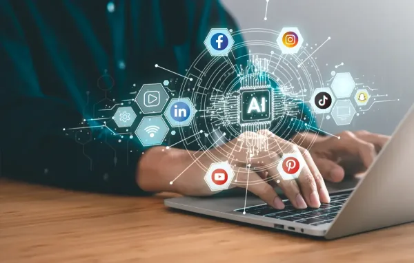 Hands typing on a laptop with social media logos in a circle around the words AI